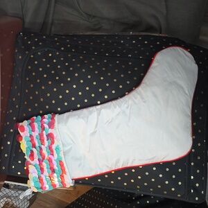 White stocking with red trim and colorful sequins